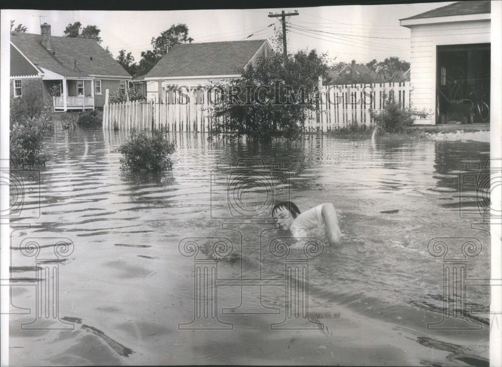 1958 Youngster swim in flooded area - Historic Images