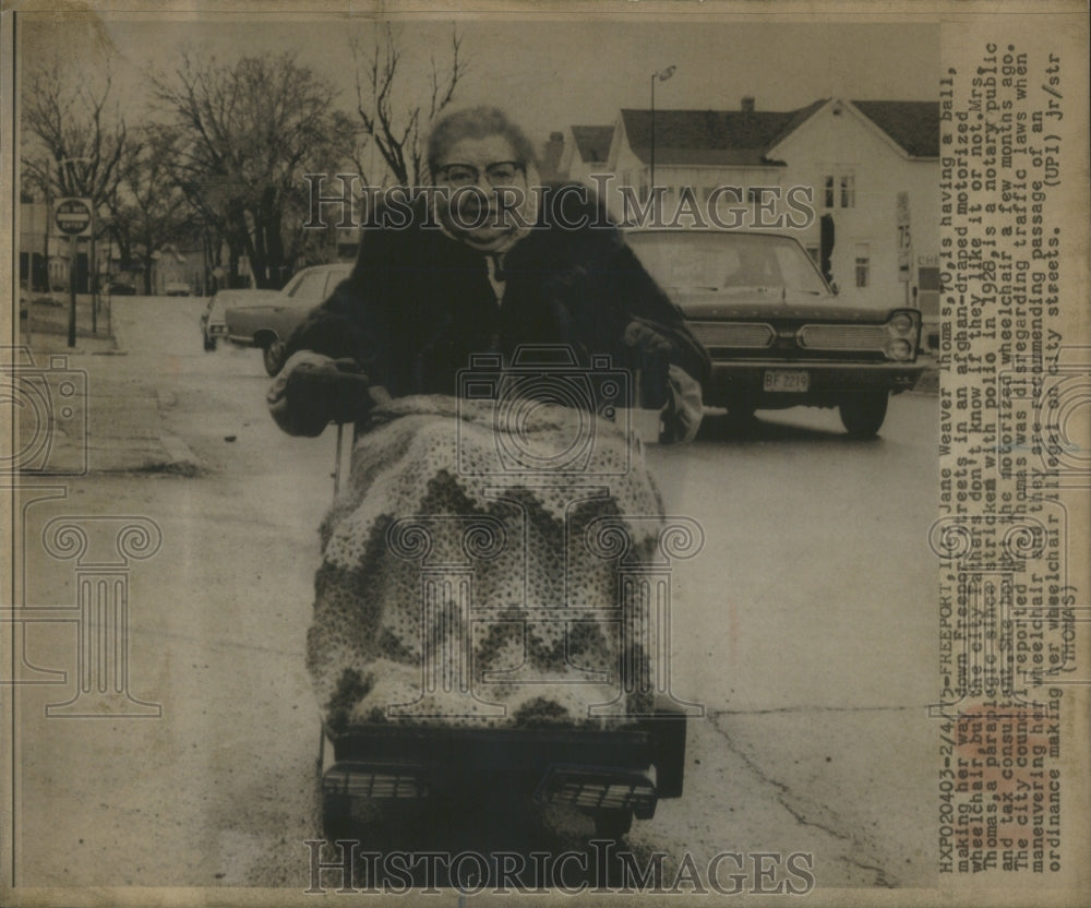 1975, Jane Waaver Thomas wheelchair streets - RRU85877 - Historic Images