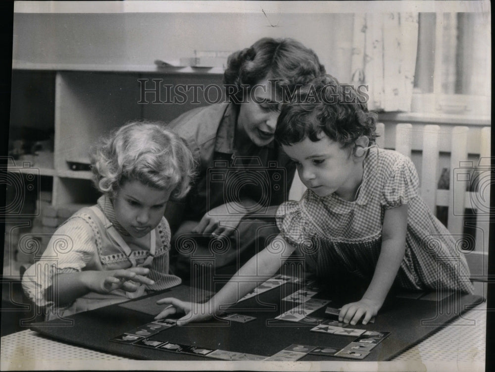 1962 Using hearing aids, Judy &amp; Ann respond  - Historic Images