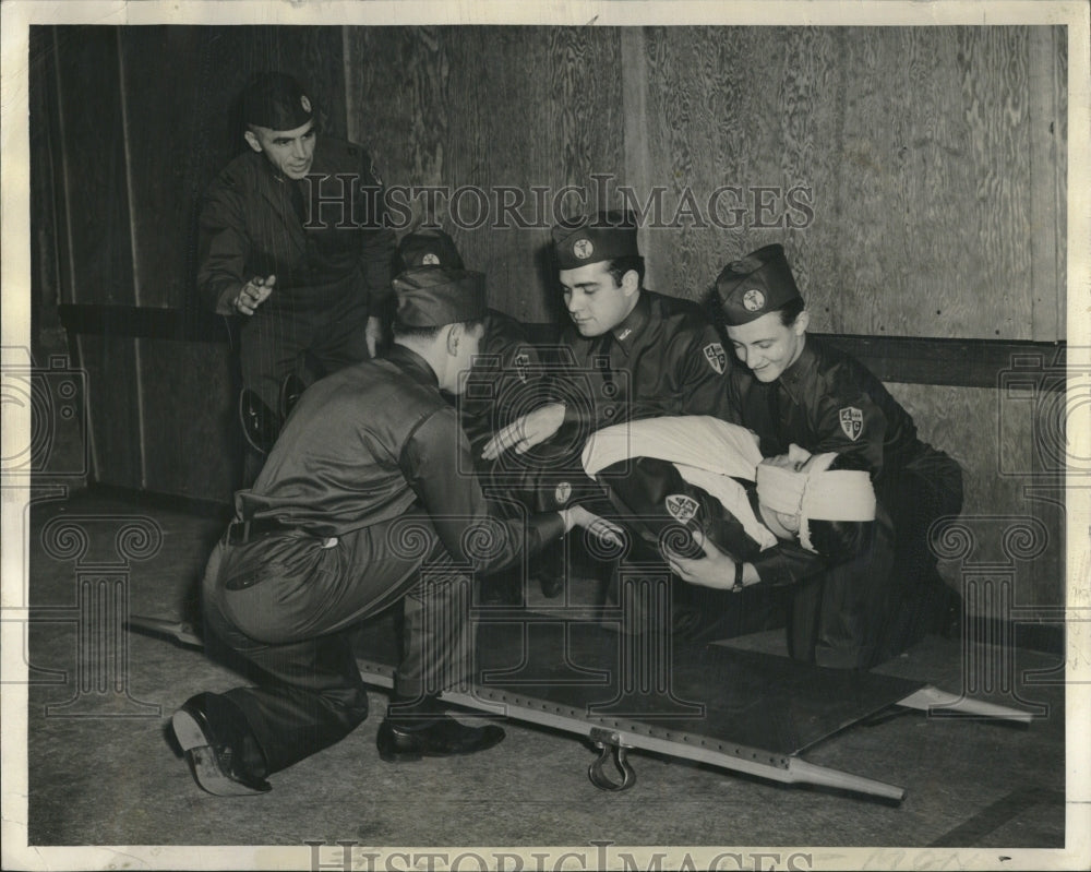 1940, Captain J.R. Smith cadets stretcher - RRV18873 - Historic Images