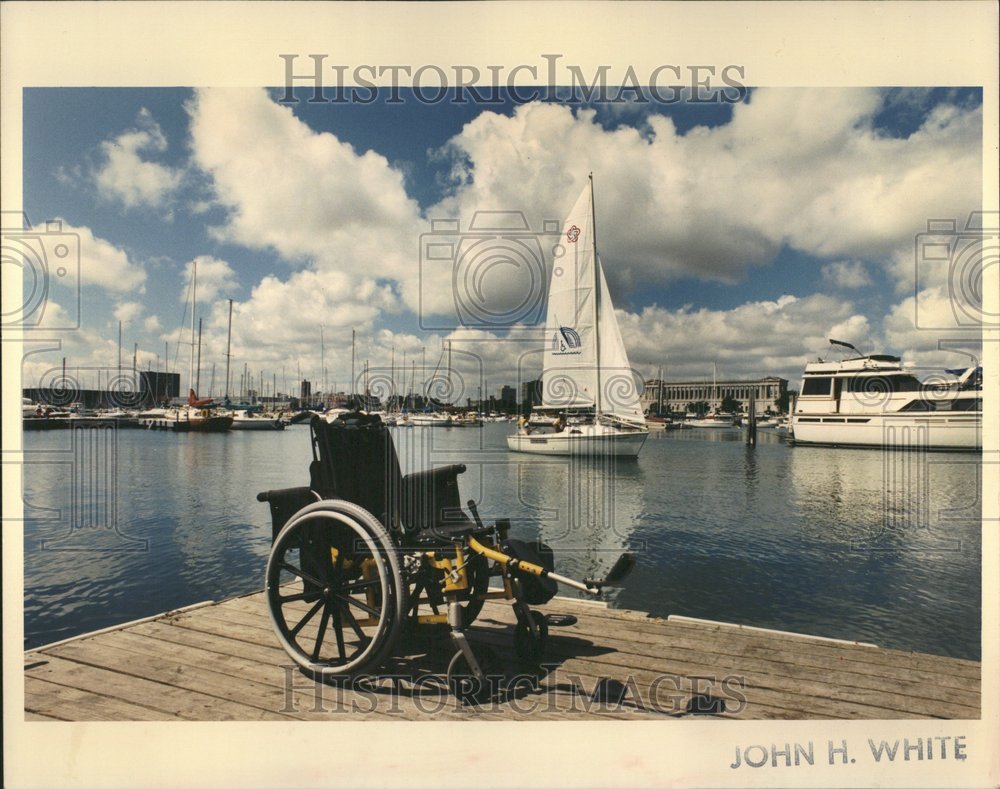 1991 Empty Wheelchair On Dock With Sailboat - Historic Images