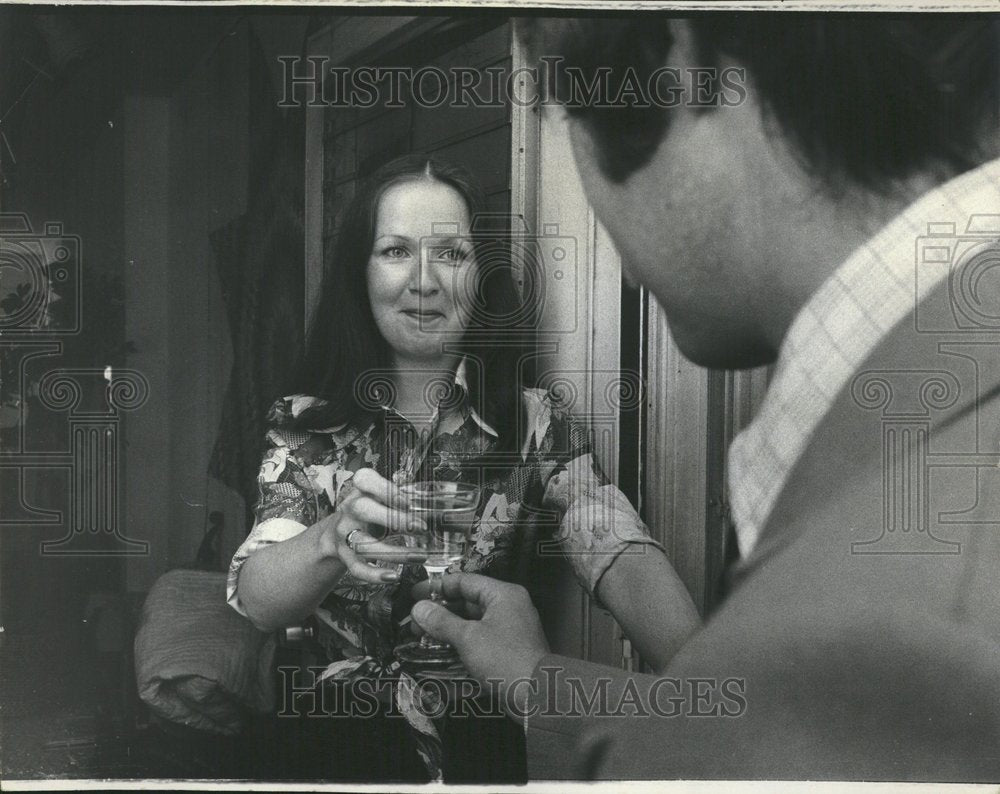 1975 Woman Handing Man Martini - Historic Images