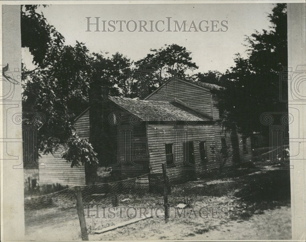 Press Photo Wooden Cabin Surrounded By Trees - Historic Images