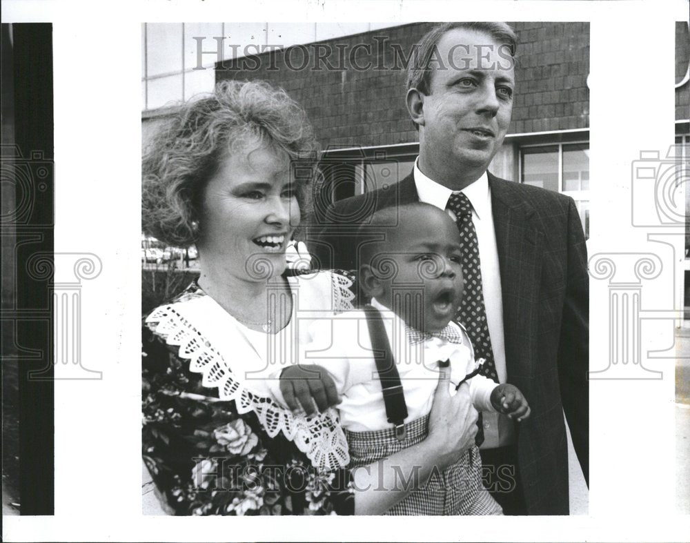 1996 White couple adopts black baby boy - Historic Images