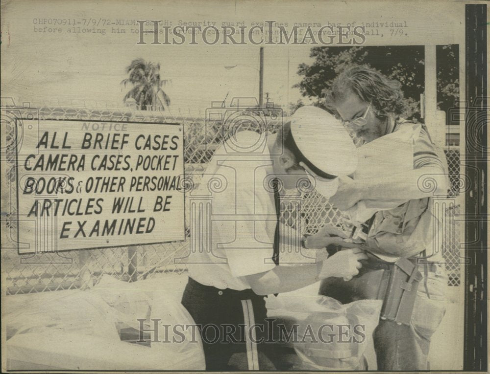 1972 Security Examines Camera Bag - Historic Images