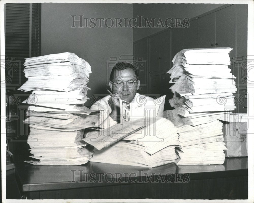 Press Photo Man With Mounds Of Paperwork Office - Historic Images