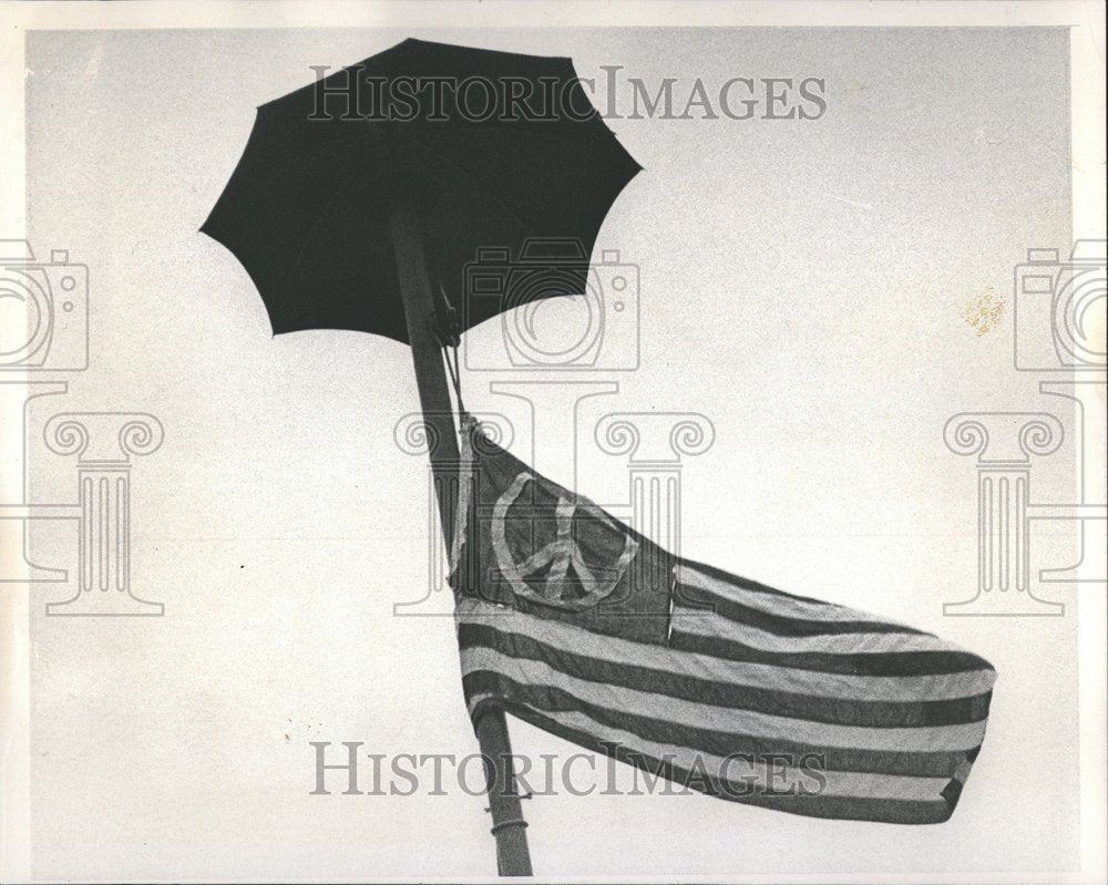 1970 Flag pole umbrella Several people one-Historic Images