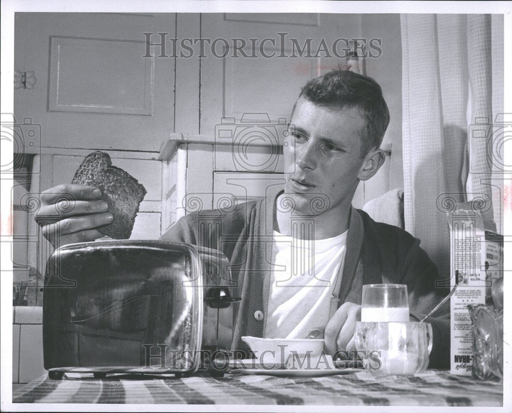 1956 Factory worker breakfast toast burns-Historic Images