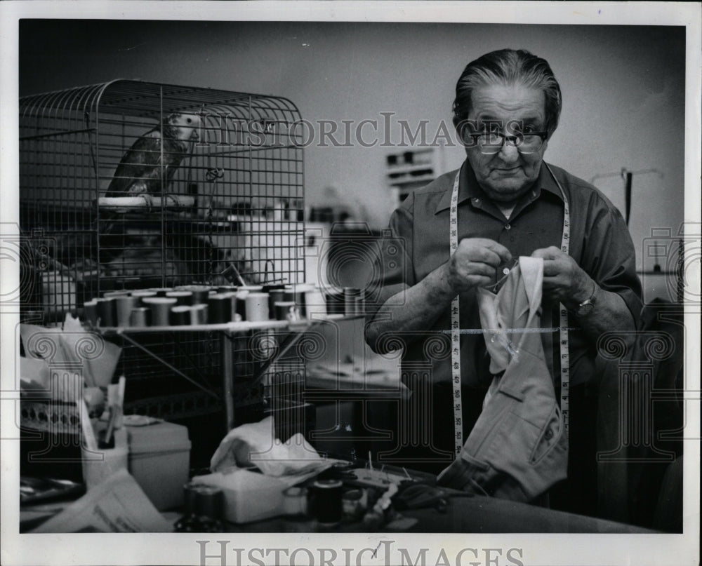 1977 Press Photo Tailor Pants Bird Thread Tape Measure - RRW02269 - Historic Images