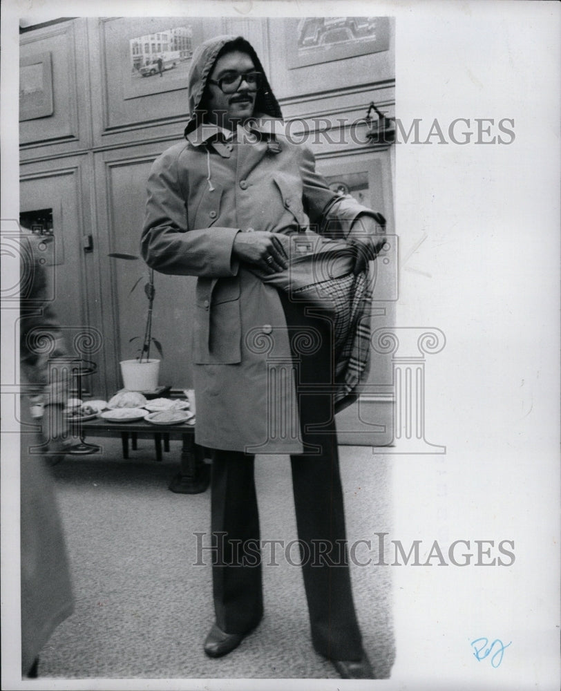 1977 Press Photo Policeman Donated Hooded Raincoat - RRW13217 - Historic Images