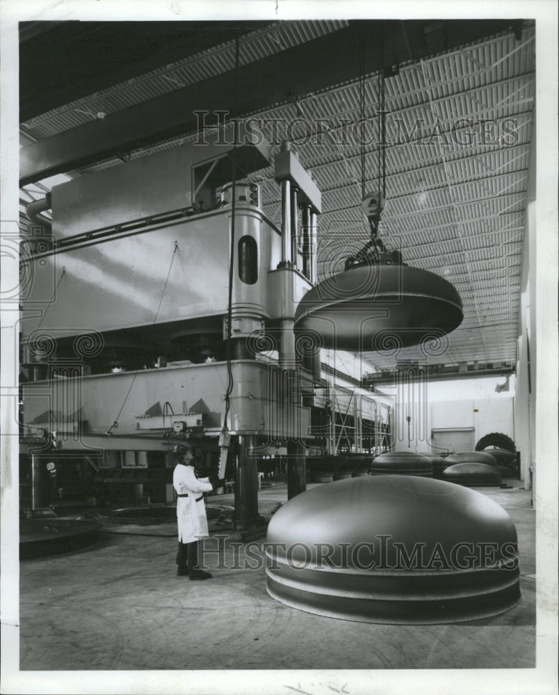 1968 Press Photo Workman Watches Head Press - RRW37139 - Historic Images