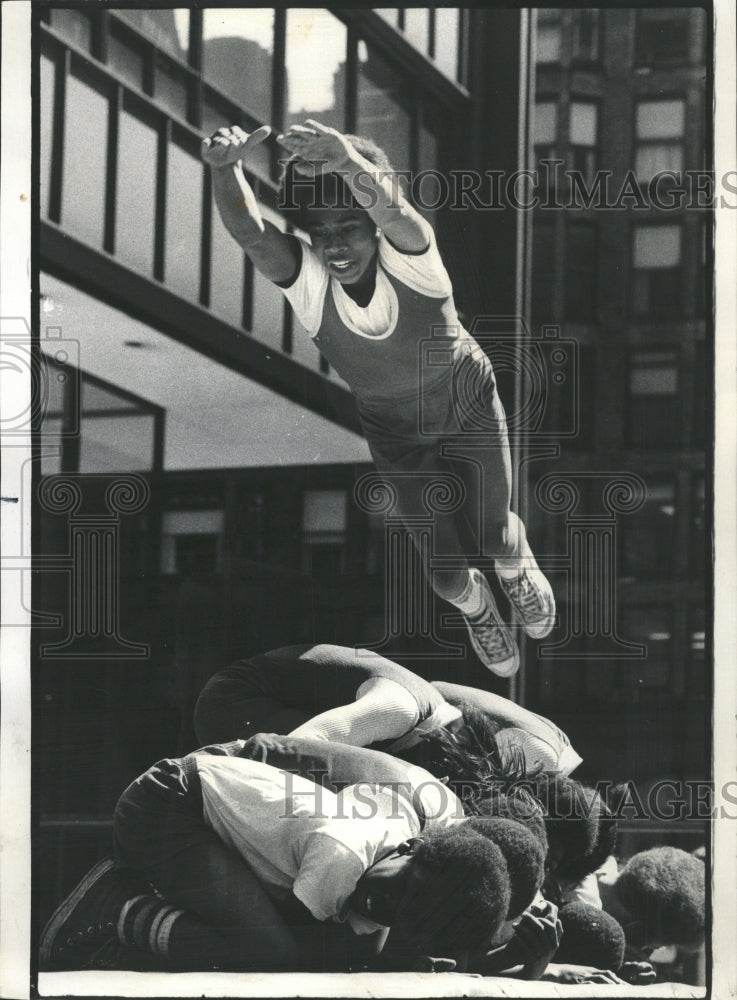 1974 Press Photo Boy Tumbling Over Classmates Chicago - RRW45269 - Historic Images