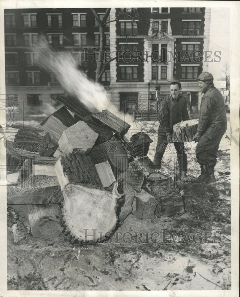 1953 Press Photo Men Cut Down And Burn Tree - RRW45851 - Historic Images