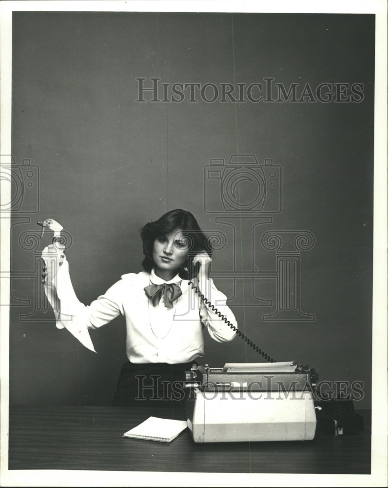 1980 Press Photo Woman Typewriter Phone Spray Bottle - RRW47261 - Historic Images