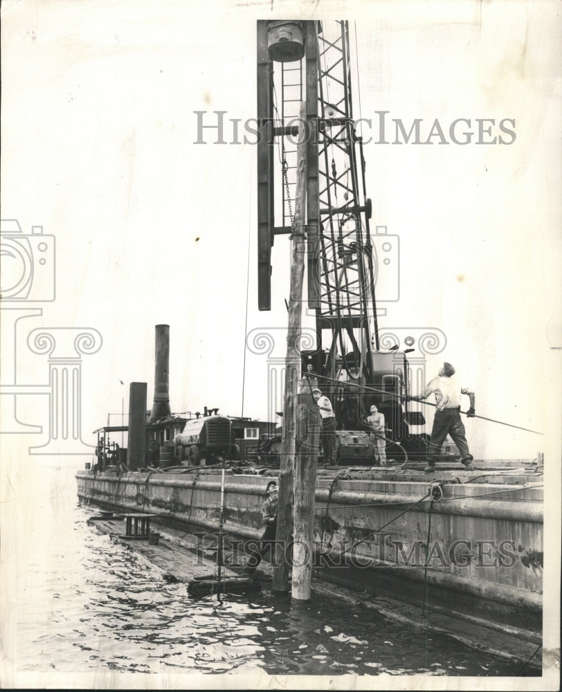 1954 Press Photo File Positioned sinking Skyline Work - RRW50255 - Historic Images