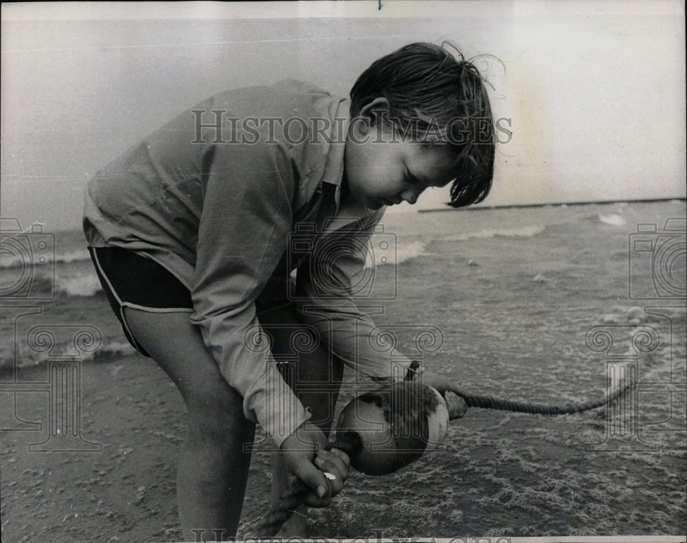 1970 Press Photo Marker buoy examined by Roy Coburn. - RRW66657 - Historic Images