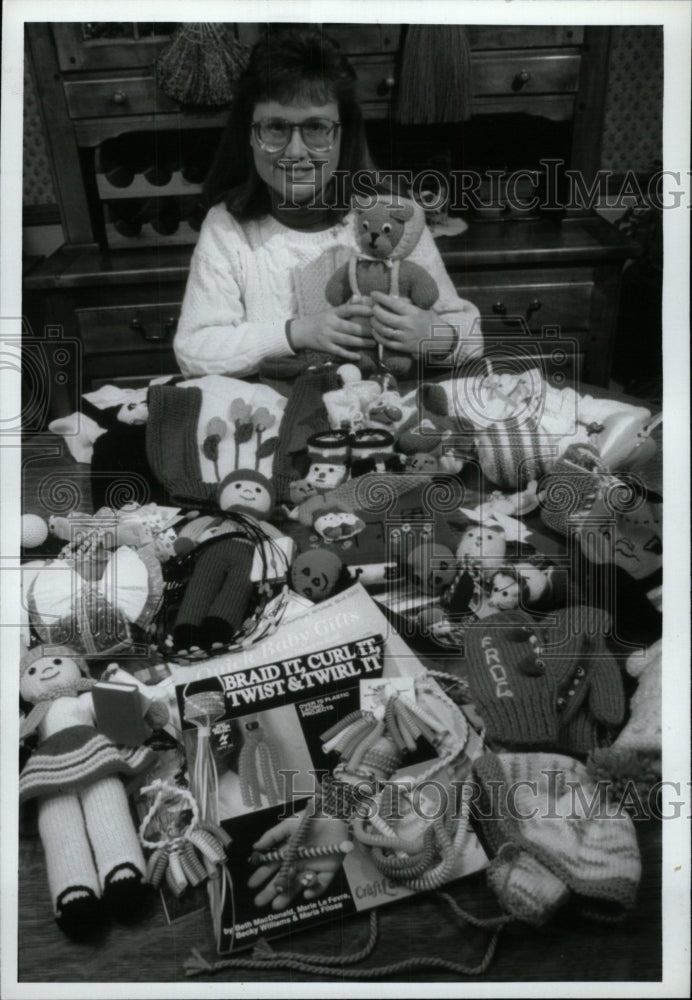 1993 Press Photo Different Handcraft lady play Booties - RRW72615 - Historic Images