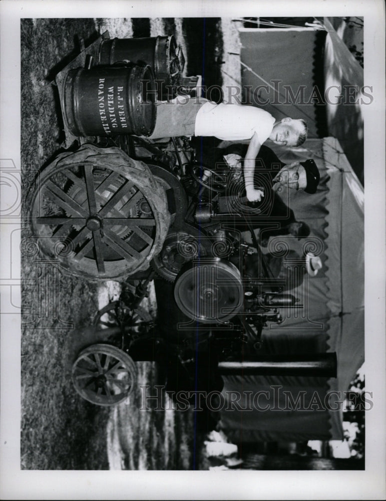 Press Photo Boy Works Thresher B.J. Fehr Welding - RRW73167 - Historic Images