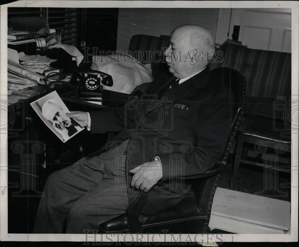 1959 Press Photo Dr. Rudalph Albi admires picture hero - RRW85391 - Historic Images