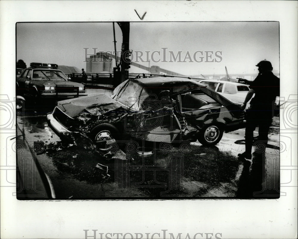 1987 Press Photo City Police Officer Look Over Crumple - RRW86657 - Historic Images