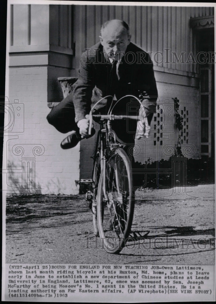 1963 Press Photo Owen Lattimore riding a bicycle - RRW97781 - Historic Images