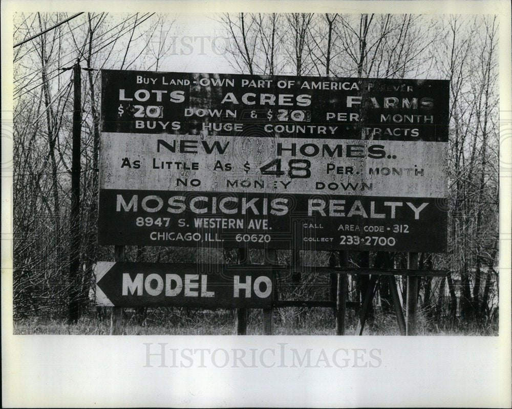 1982&quot;Buy Land&quot; Sign board blares in Weather - Historic Images