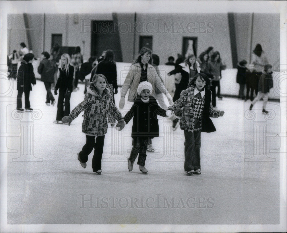 1972 Children enjoying ice skating. - Historic Images