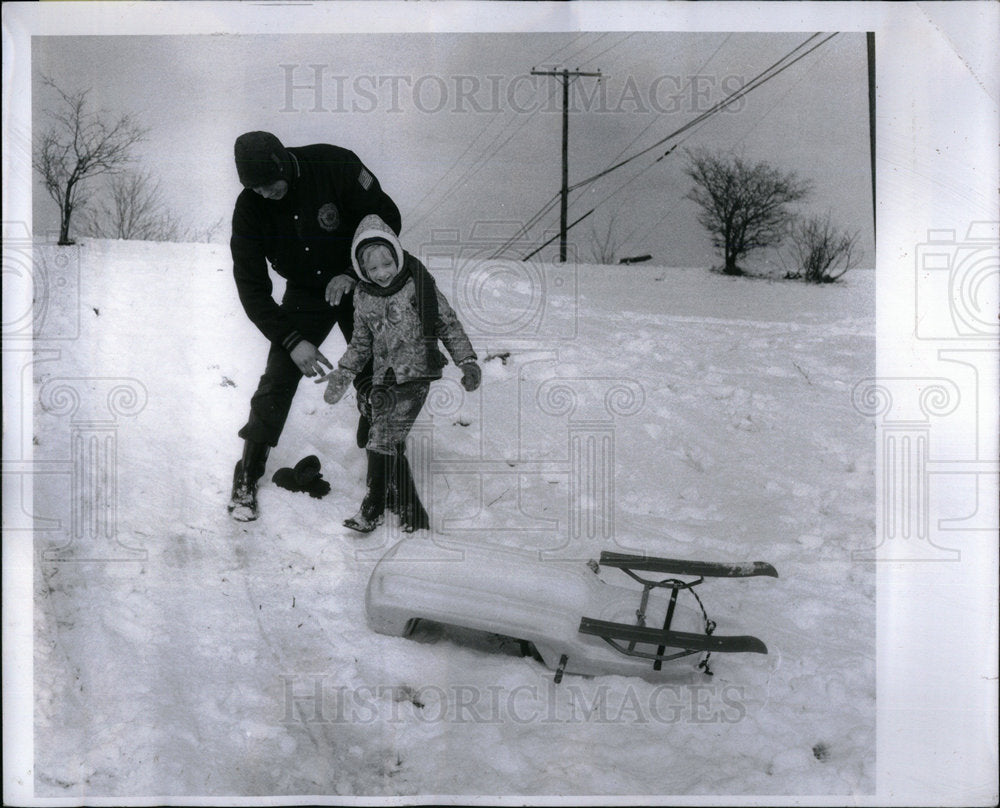 1973 Twin Girl Falls Snowsled Dad Helps - Historic Images