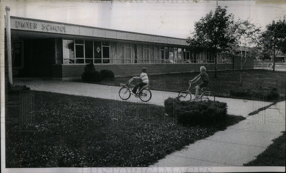 1974 Neighboring kids cycling past School - Historic Images