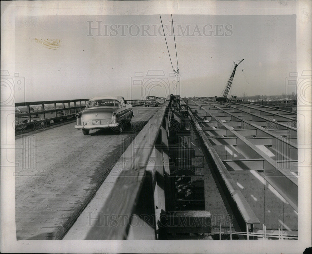 car over bridge construction - Historic Images