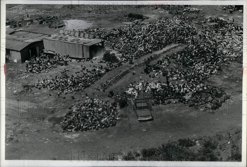 1980 helicopter view of an illegal dump sit - Historic Images