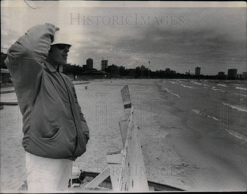 1972 Garry Owen stands on north ave beach. - Historic Images