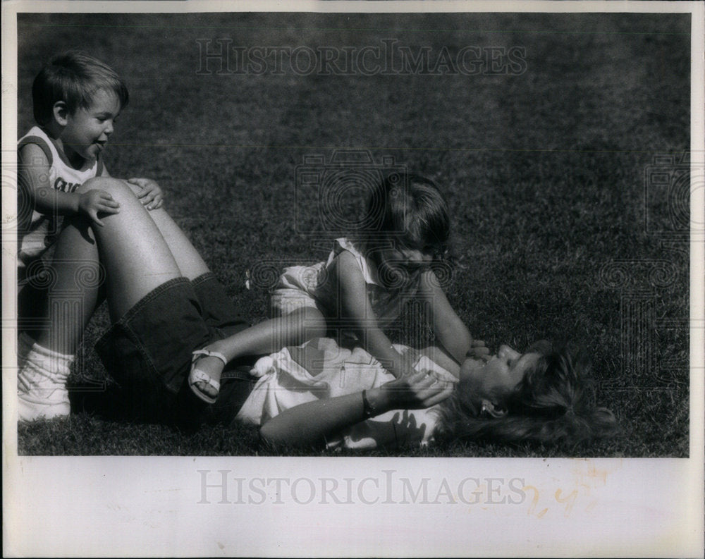 1988 Baby-Sitter Has Park Day With Kids - Historic Images