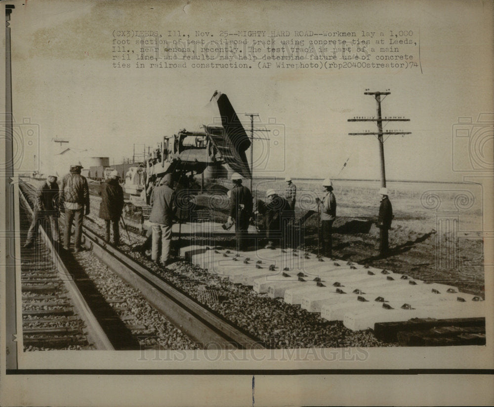 1974 workmen lays a 1,000 foot section - Historic Images