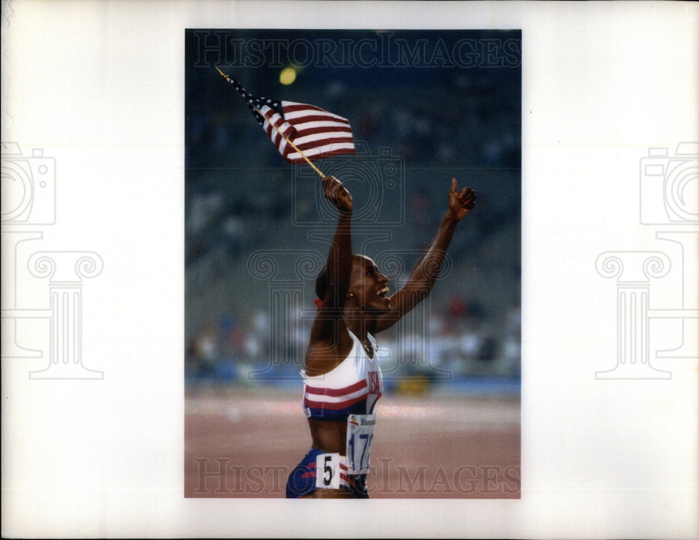 Girl waves a  USA flag in a victory praise - Historic Images