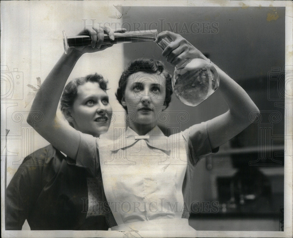 1957 Nurse Mixes Chemicals in Laboratory - Historic Images