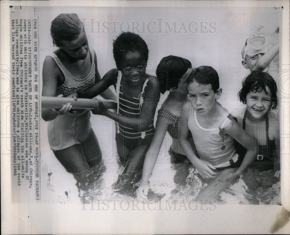 1965 children playing in the pool. - Historic Images