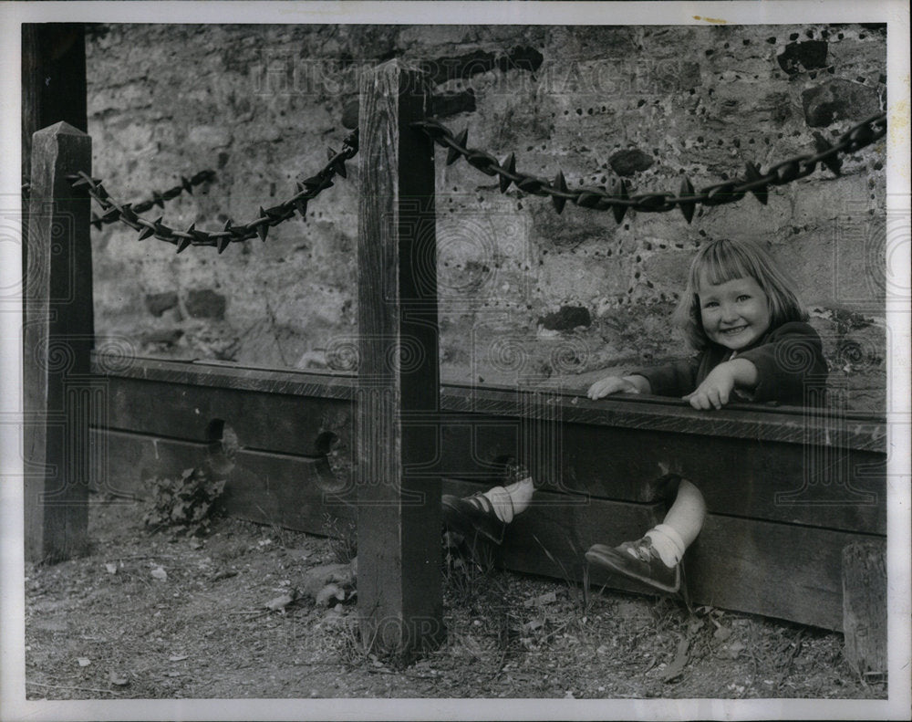 1956 Blond Little Girl Playing in Stocks - Historic Images