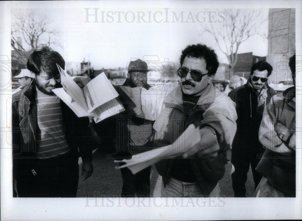 1993 Sadegh Hatami cabdriver waves ticket - Historic Images