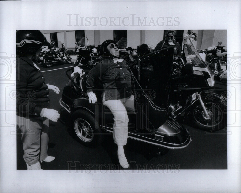 1992 Woman Struggling To Get Out Side Car-Historic Images