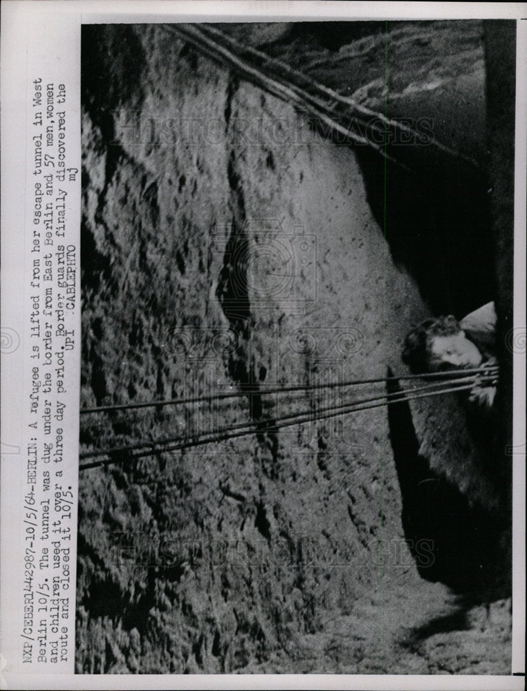 1964 Press Photo Lady Refugee Lifted From Escape Tunnel - Historic Images