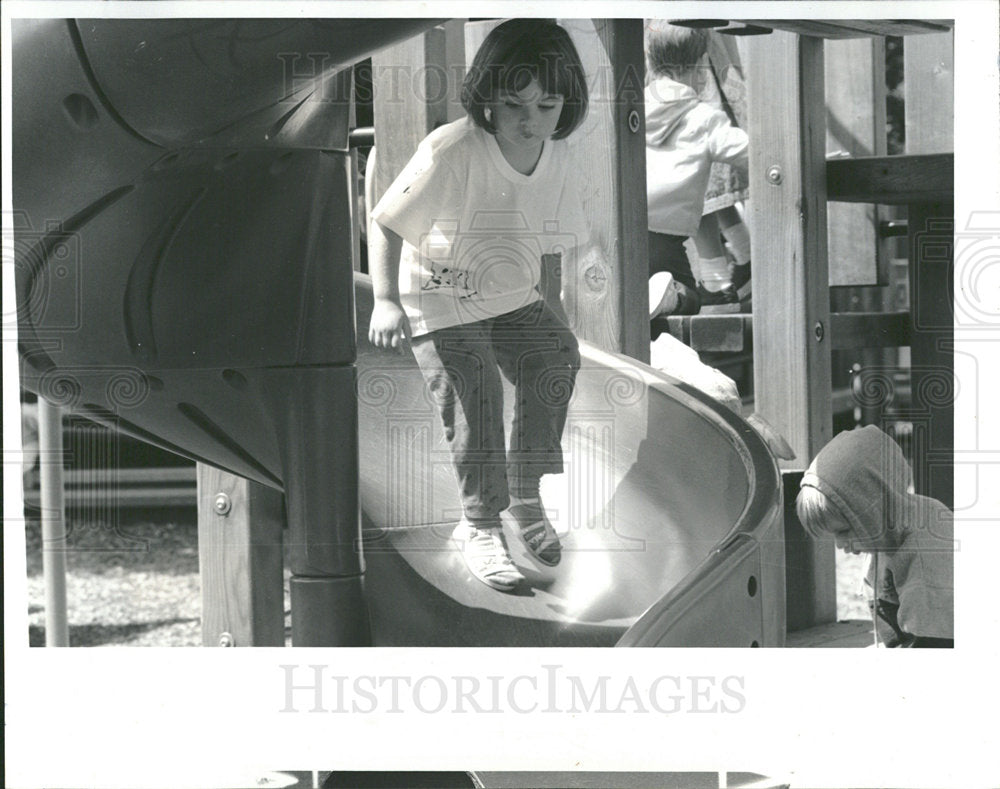 1992 Press Photo Caitlin Webb explores ways down slide - Historic Images
