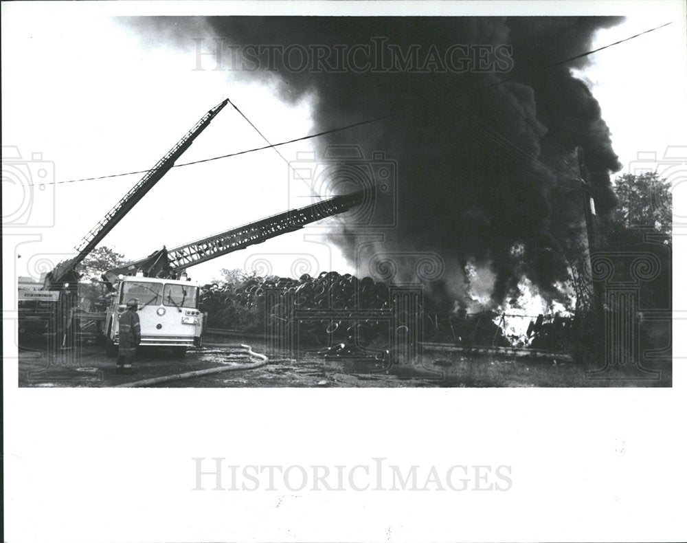 1990 Press Photo Old Tires in Fire Next to Private Home - Historic Images