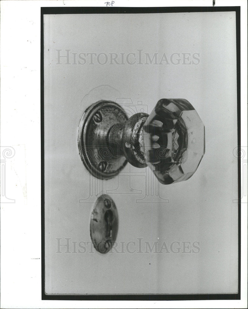1991 Press Photo Touches glass doorknob wooden floor  - Historic Images