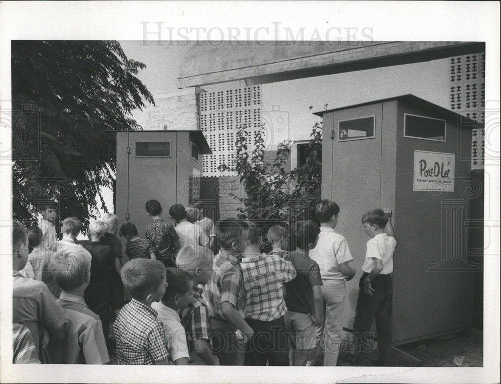 1967 Press Photo Boys standing in front of Port-O-Let. - Historic Images