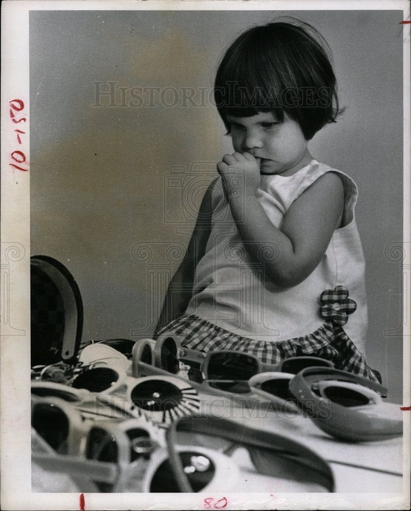 1966 Press Photo Toddler Looks At Sunglasses - Historic Images
