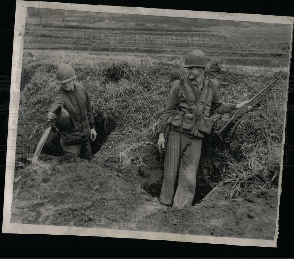 1951 Cpl. Priest bails fox hole Korea front - Historic Images