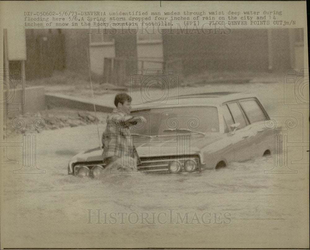1973 Press Photo Man wades flood Spring storm water  - Historic Images