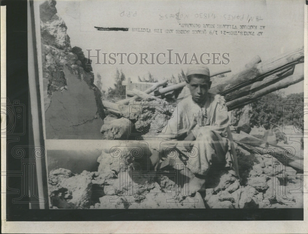 1968 Rubble surrounds youth in area near ce - Historic Images