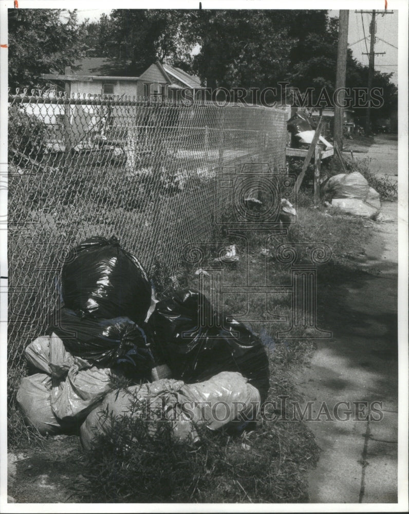 1977 Harrison Gary  Garbage bag filled tras-Historic Images